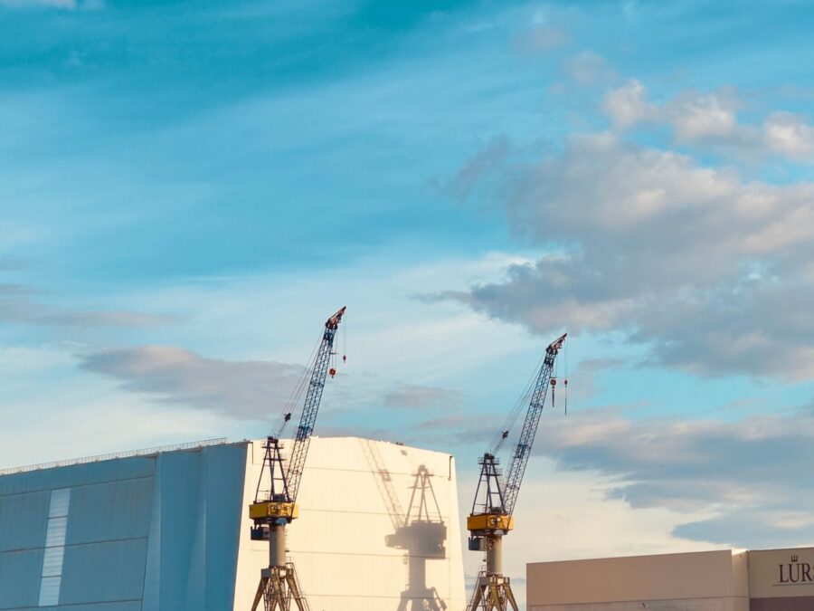Shipyard cranes around a vessel under construction