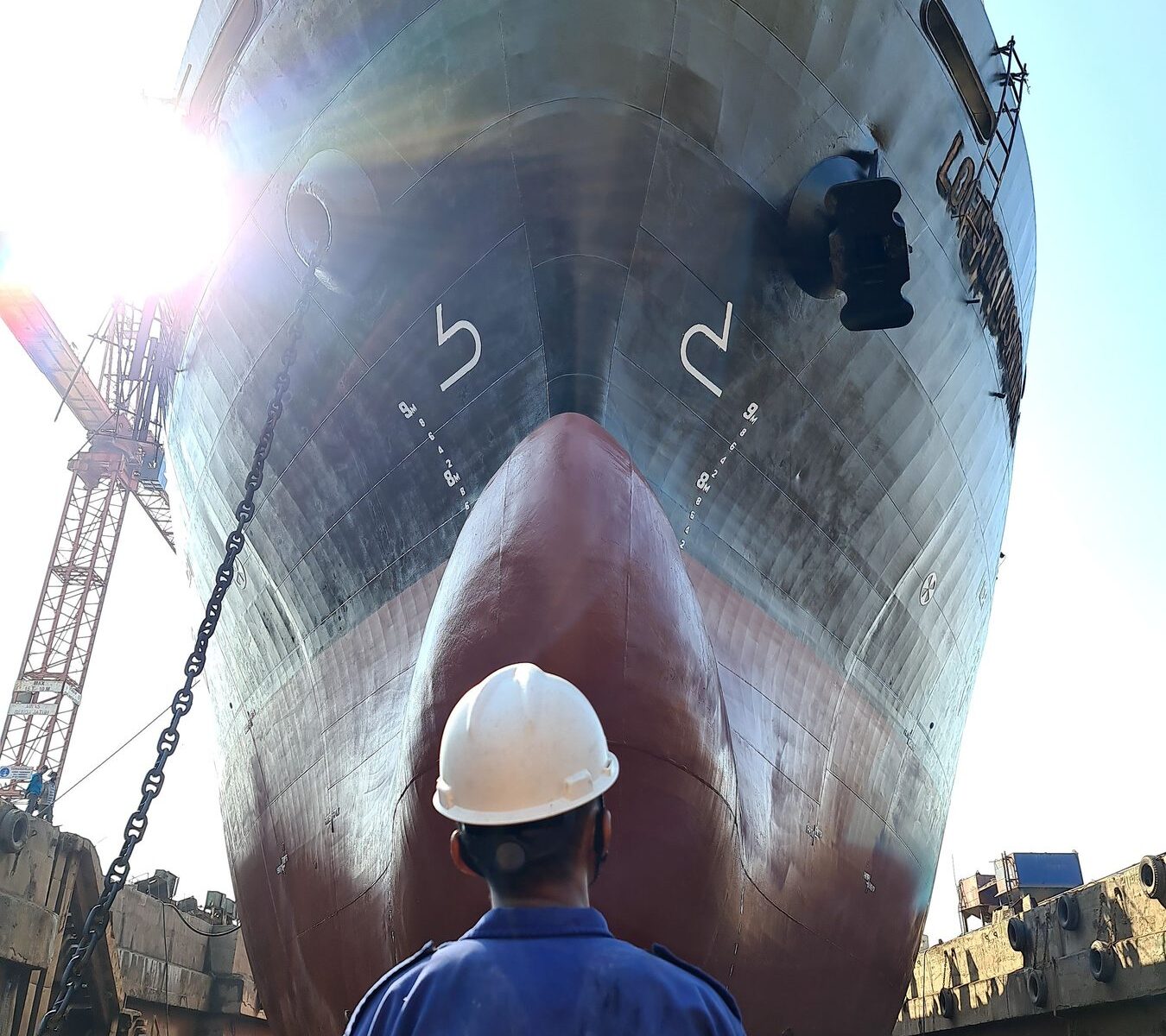 Shipyard worker carrying out vessel maintenance