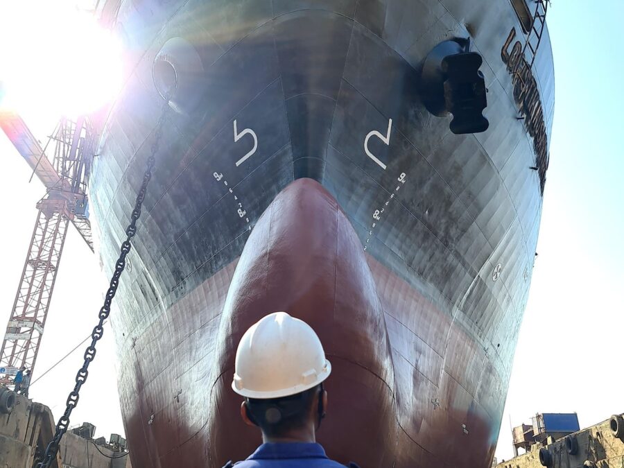 Shipyard worker carrying out vessel maintenance