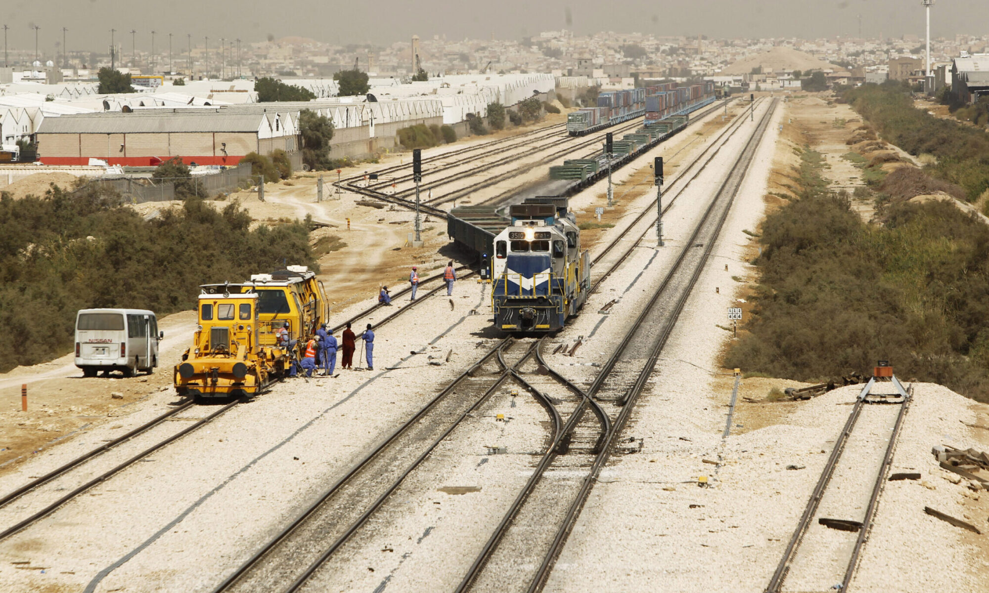 Heavy duty commercial vehicles engaged in GCC cross border trucking along a modern desert highway corridor.