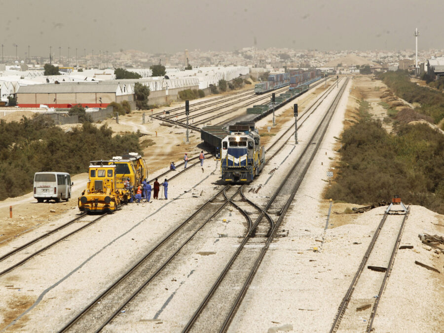 Heavy duty commercial vehicles engaged in GCC cross border trucking along a modern desert highway corridor.