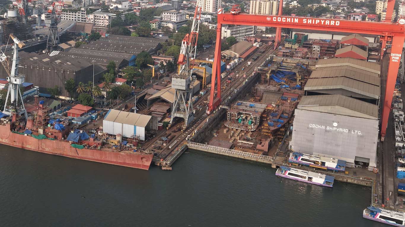 Aerial view of a commercial shipyard undergoing infrastructure upgrades under the Indian shipbuilding scheme.