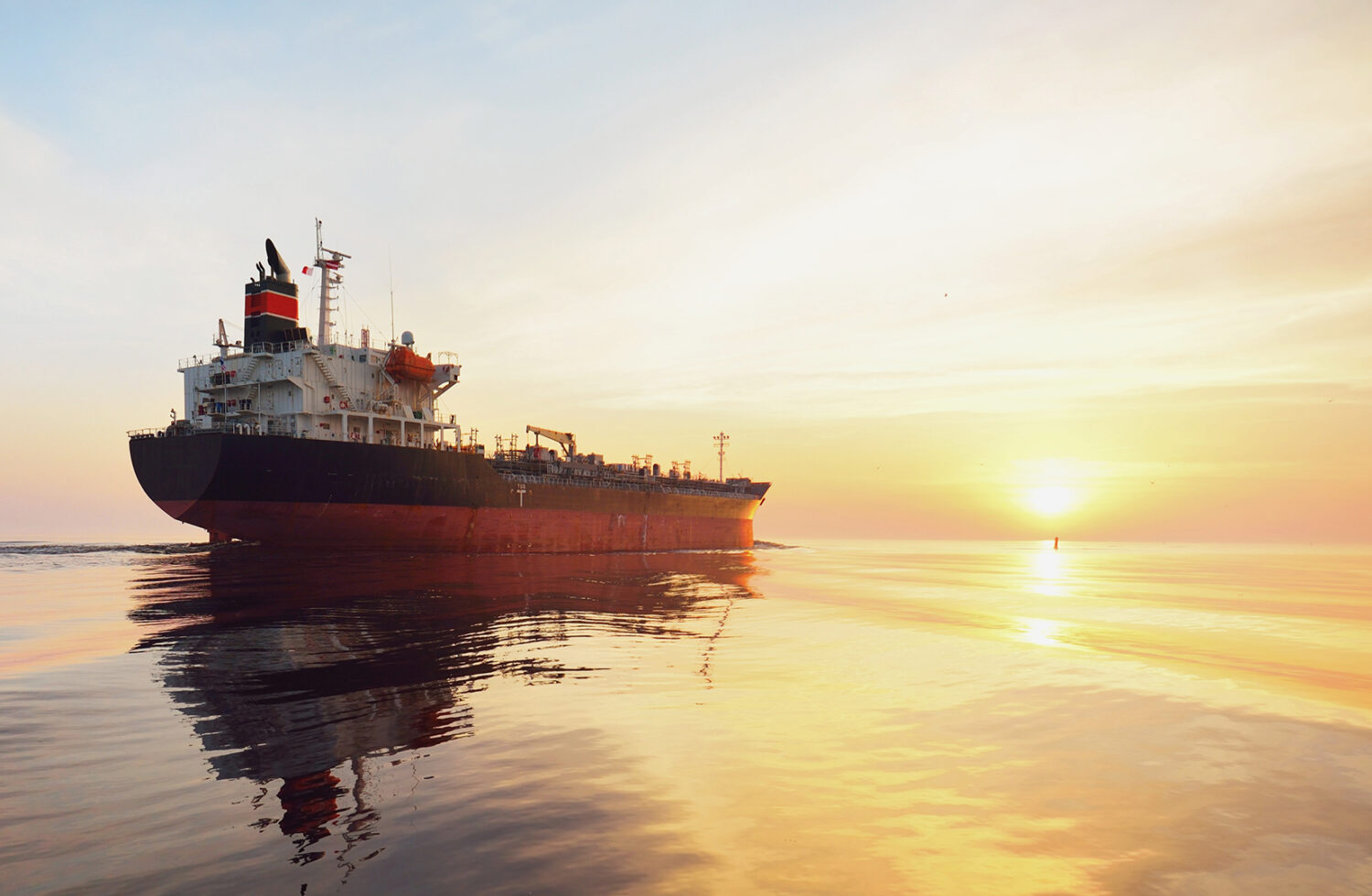 Container ship navigating regional waters where war risk clauses govern chartering decisions.