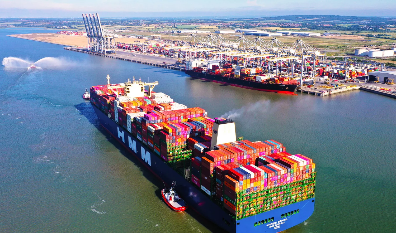 Aerial view of container ships waiting off a major port terminal during peak container port congestion.