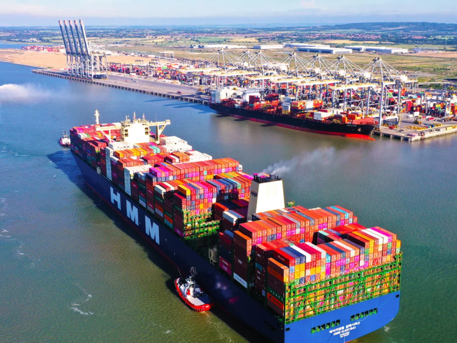Aerial view of container ships waiting off a major port terminal during peak container port congestion.