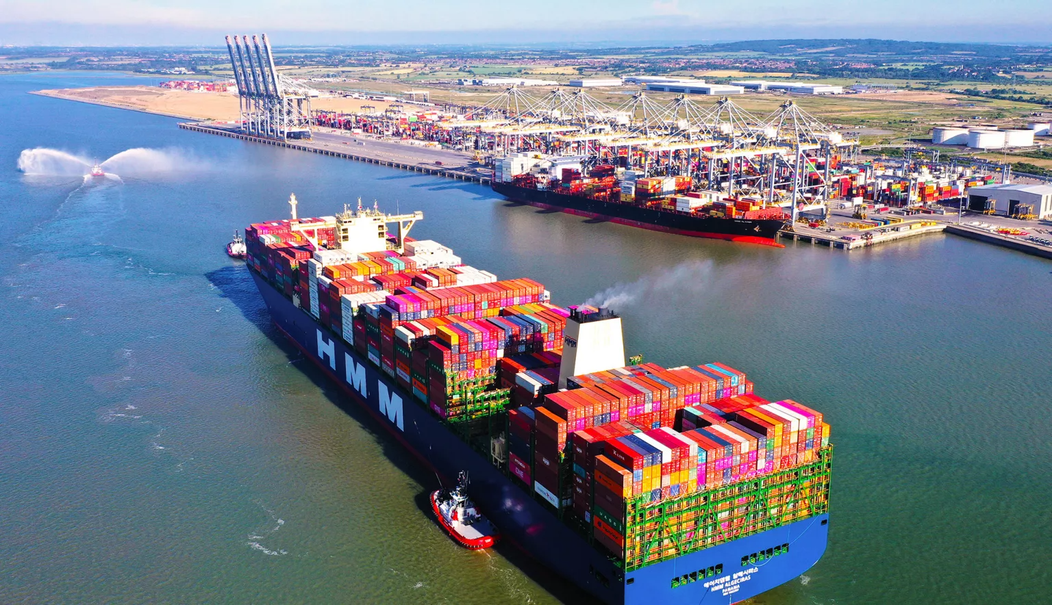 Aerial view of container ships waiting off a major port terminal during peak container port congestion.
