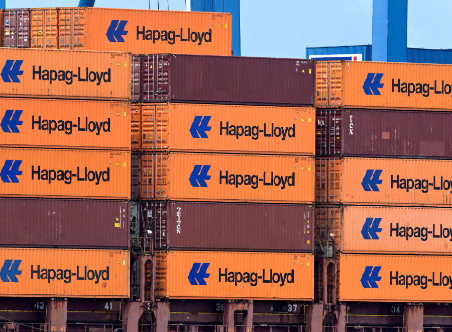 A containership at sea representing ongoing shipping regulation and merger reviews.