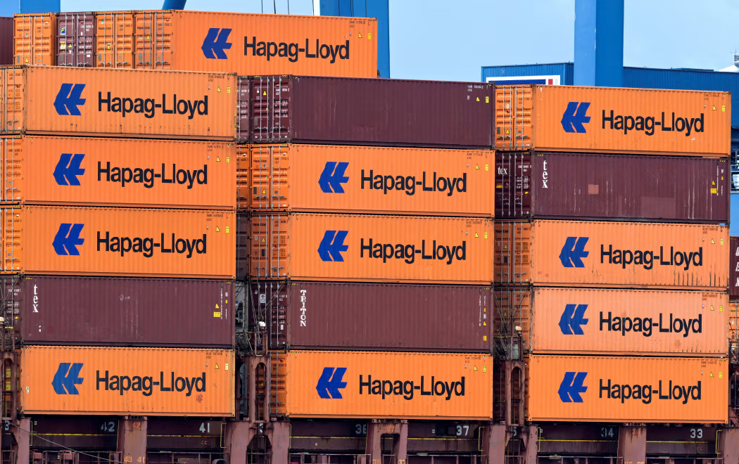 A containership at sea representing ongoing shipping regulation and merger reviews.