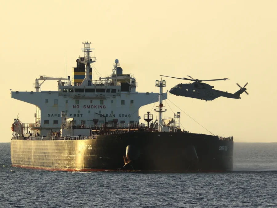 A commercial tanker navigating open waters under scrutiny regarding fraudulent ship registries and compliance.