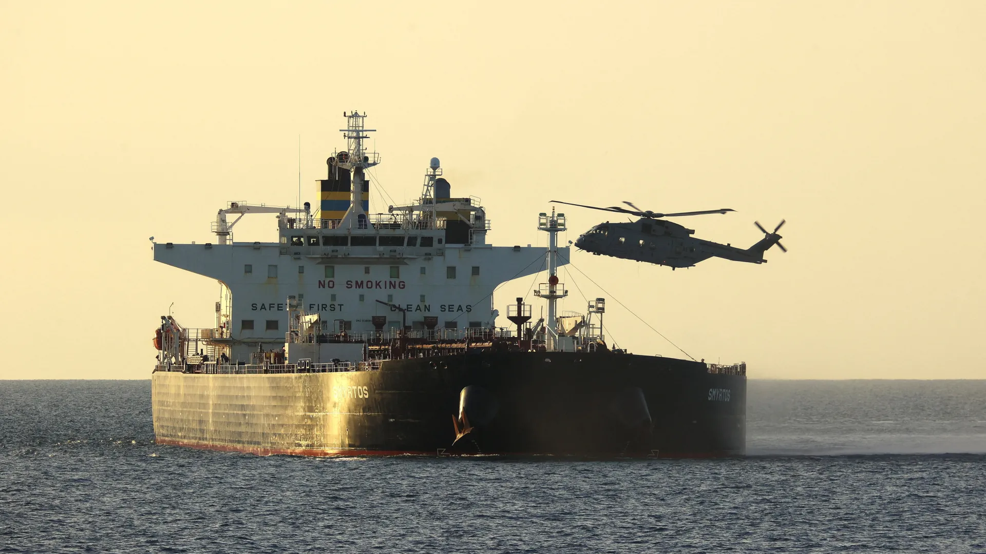 A commercial tanker navigating open waters under scrutiny regarding fraudulent ship registries and compliance.